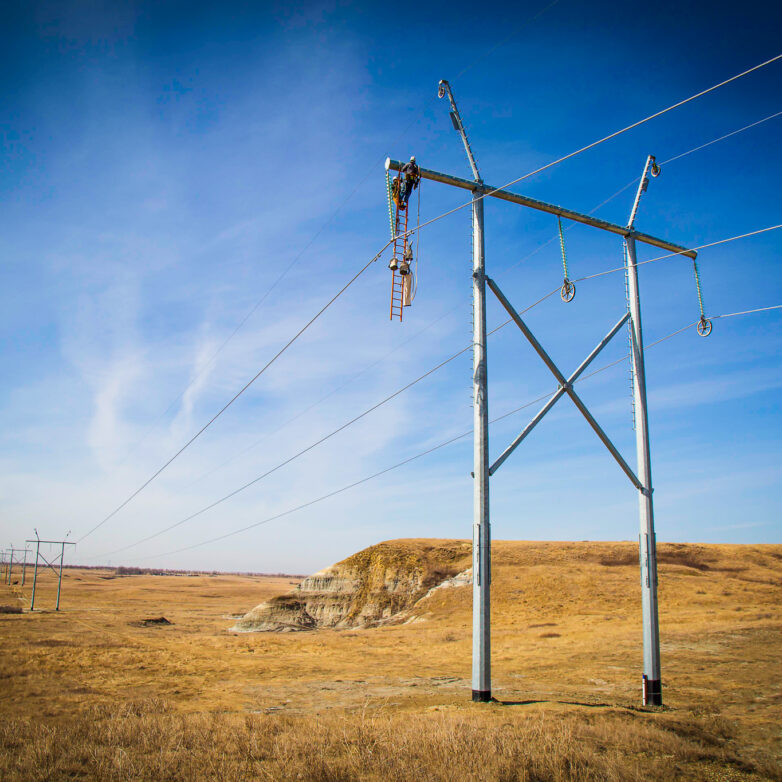 Two people working on the judson transmission towers
