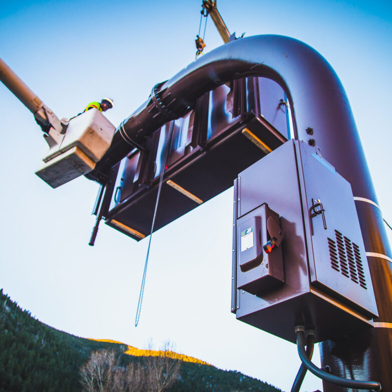 Worker on a elevated platform installing a transformer