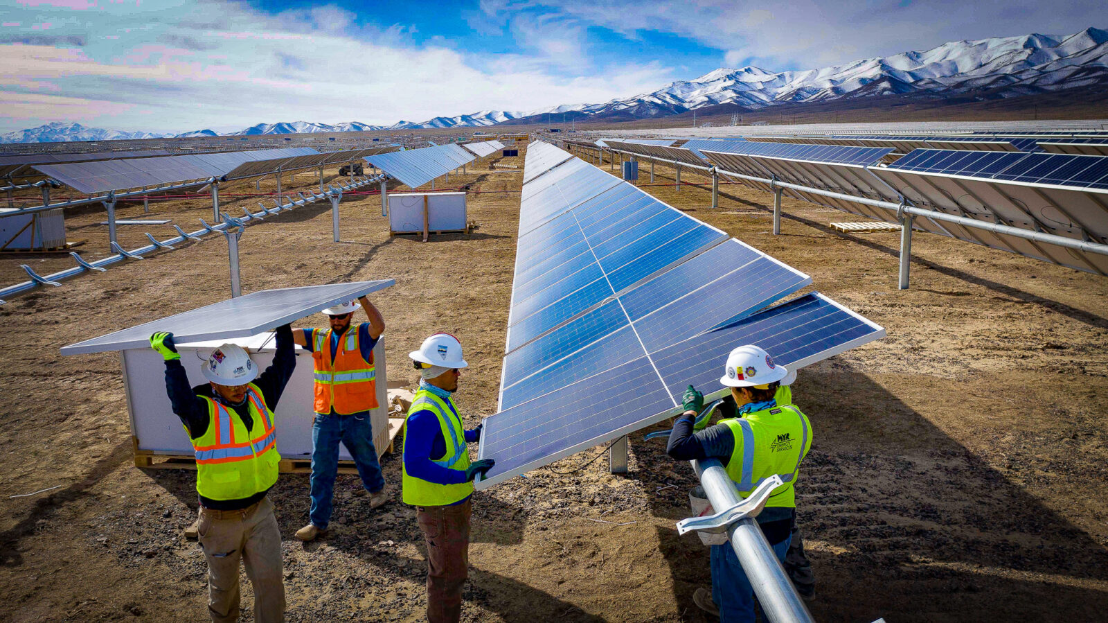 Four workers installing a solar panel