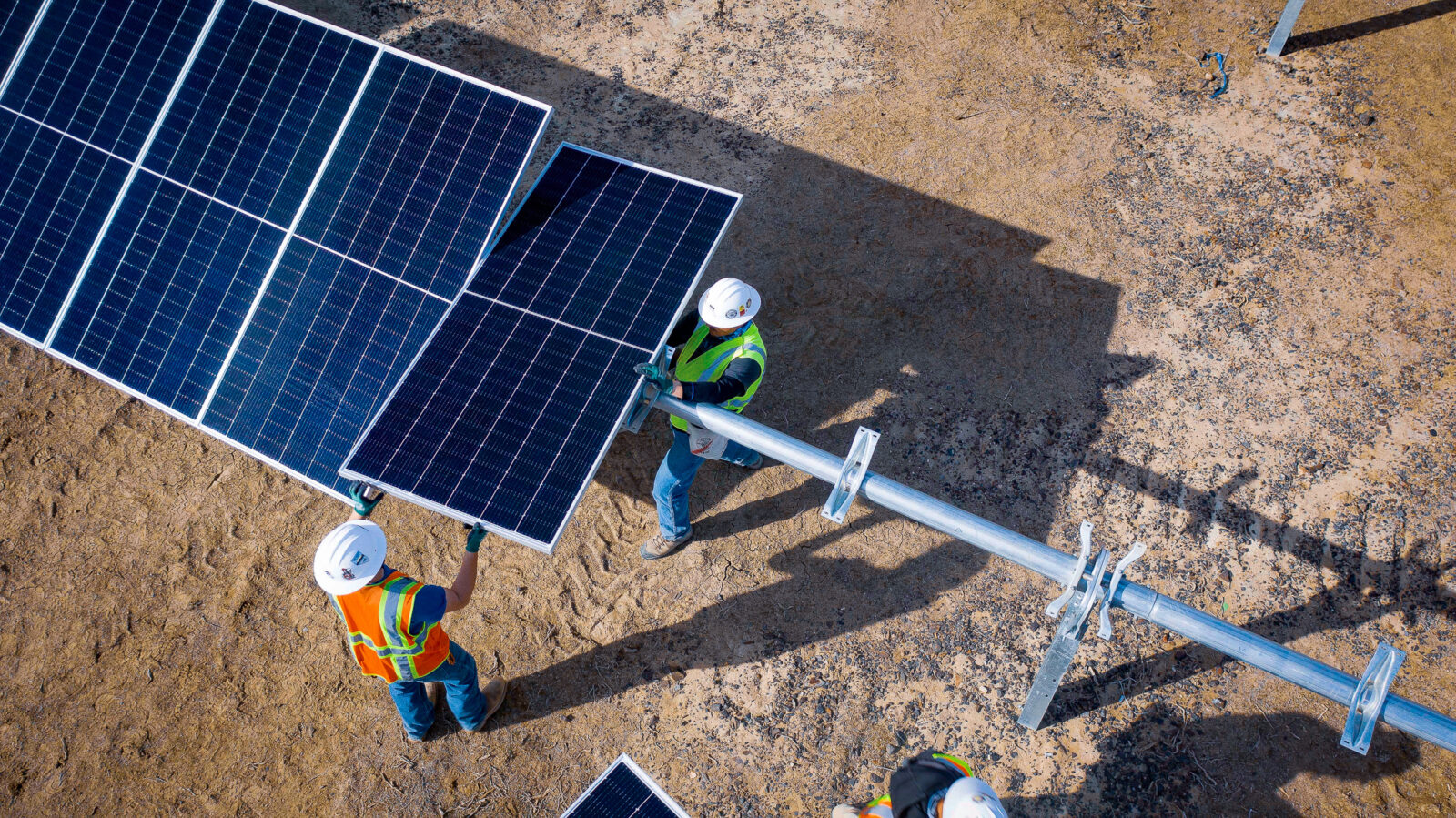 Two workers installing a solar panel
