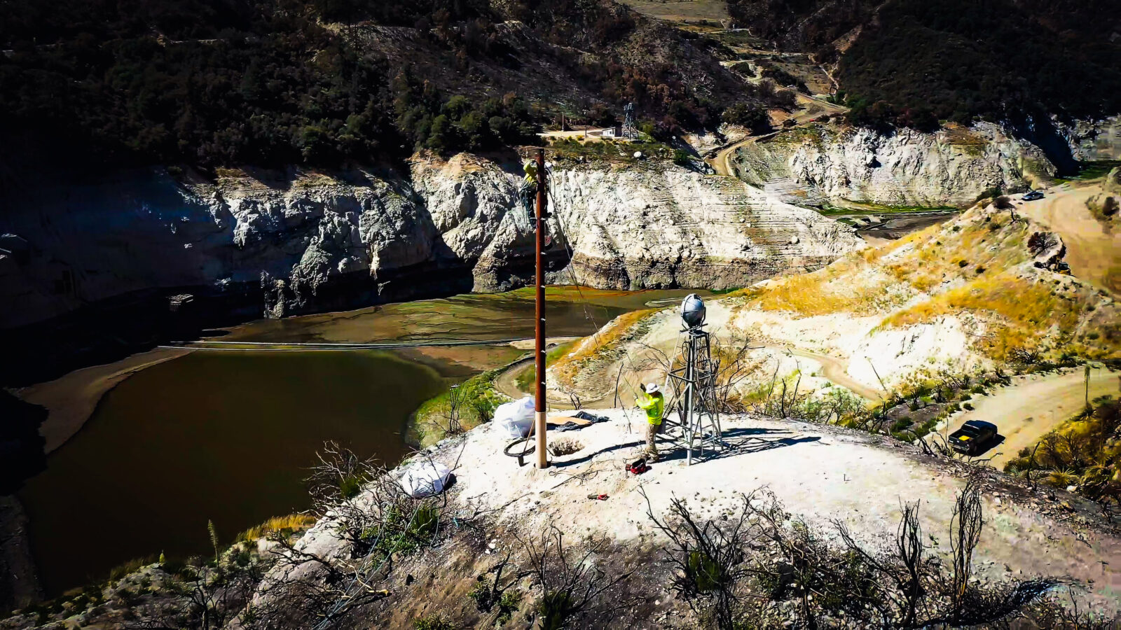 Harlan Electric worker adjusting the installation of a power line pole