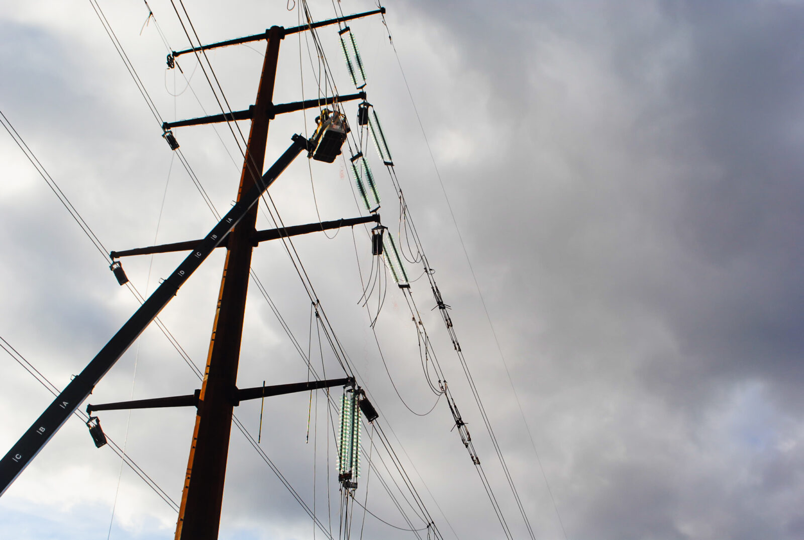 Transmission lines in a grey, cloudy sky
