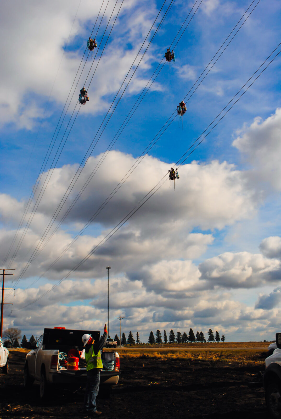L.E. Myers employee inspects transmission lines from ground level