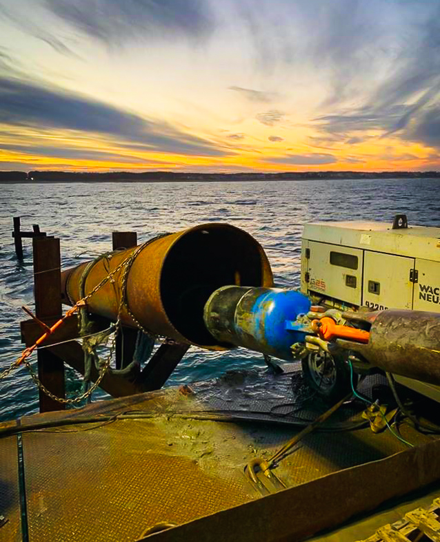 Blue tank being placed into a pipe