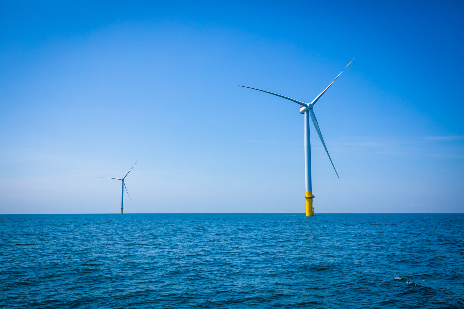Two wind turbines on an ocean