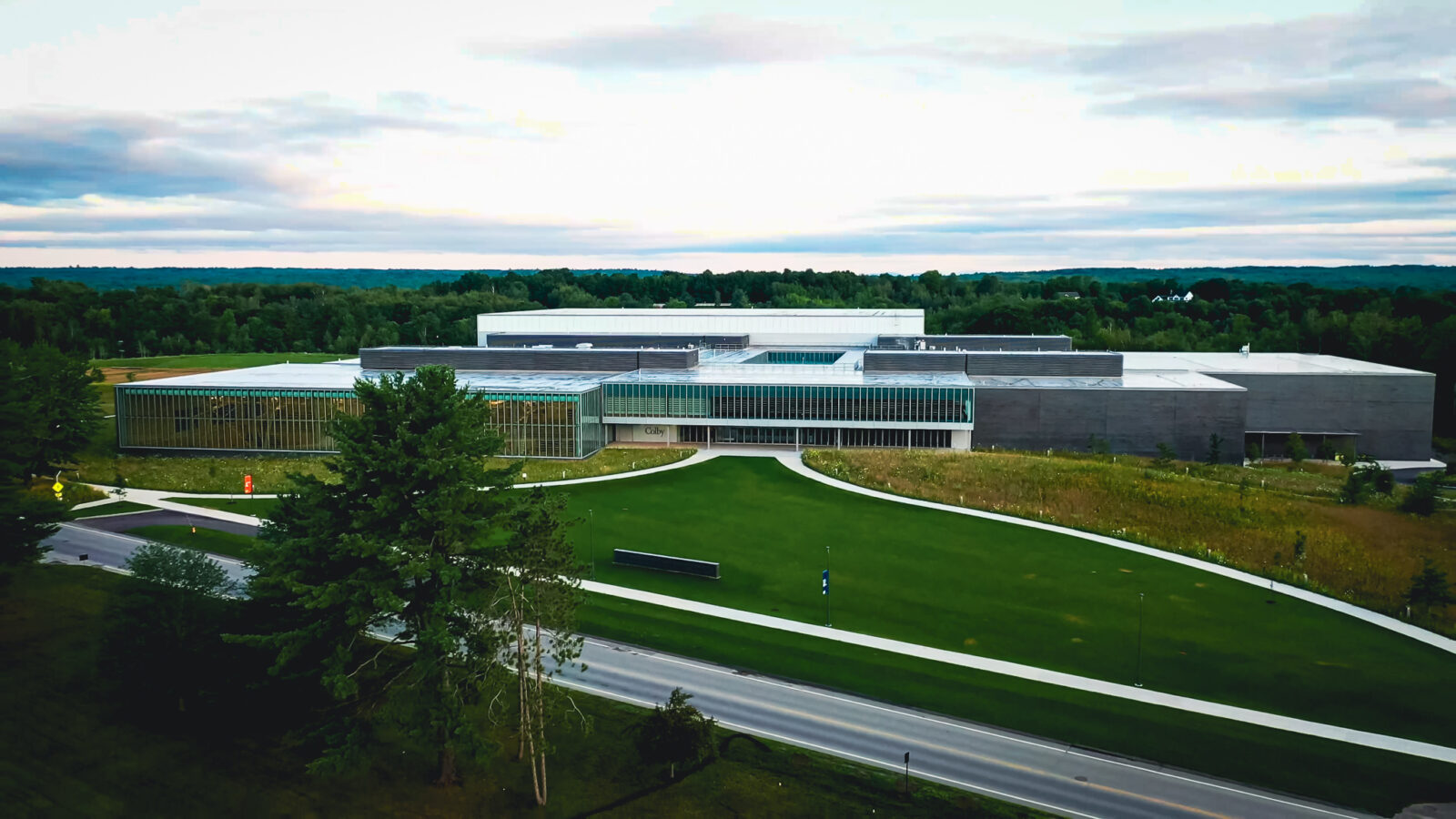 Aerial view of Colby Athletic Center with green grass field in front