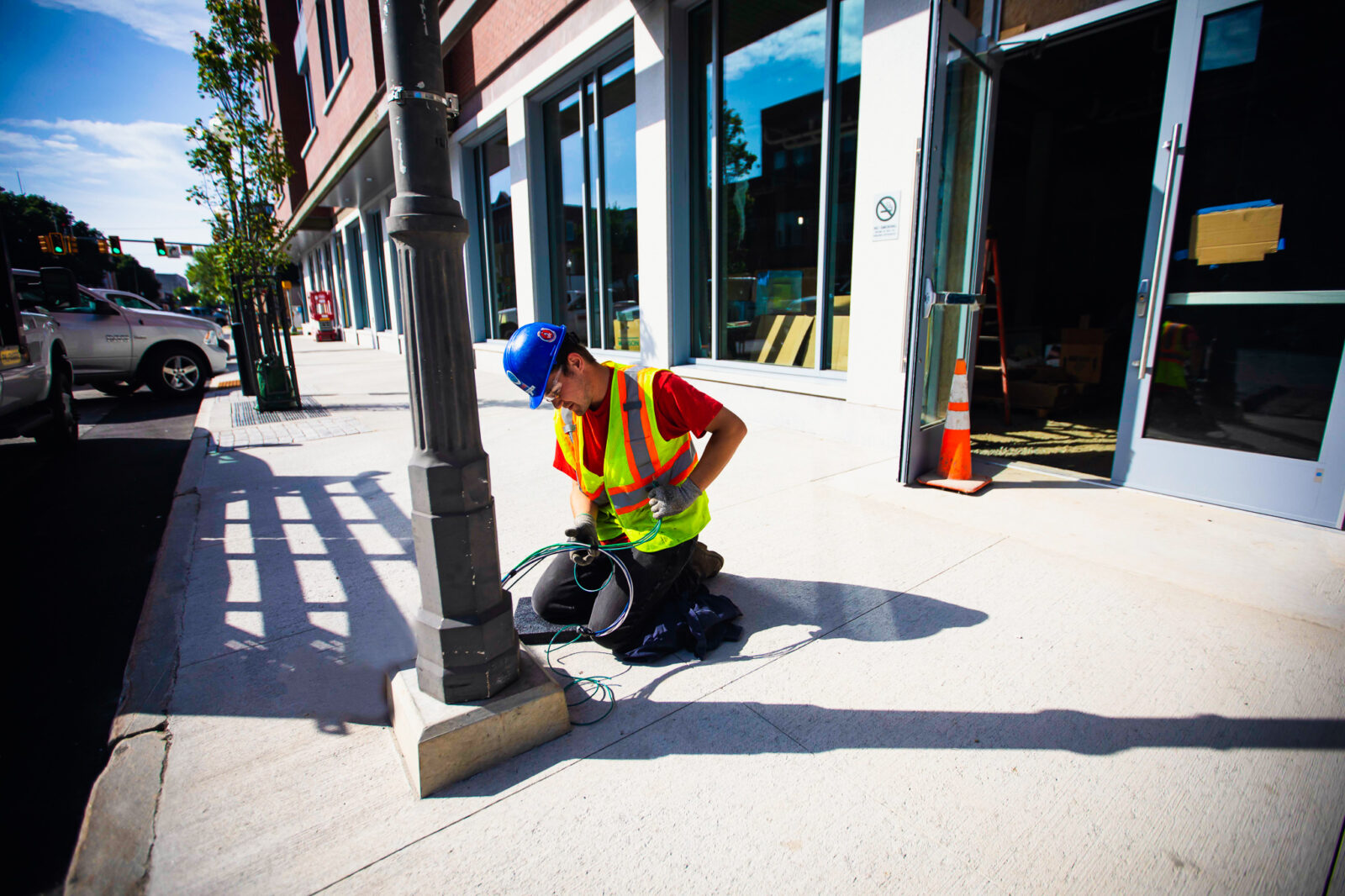 ESB worker performing electrical work on light pole on the exterior of the Colby College dorms