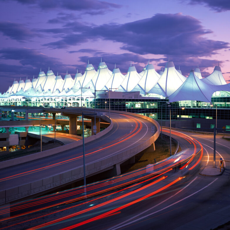 Time capture of cars driving into Denver International Airport at night