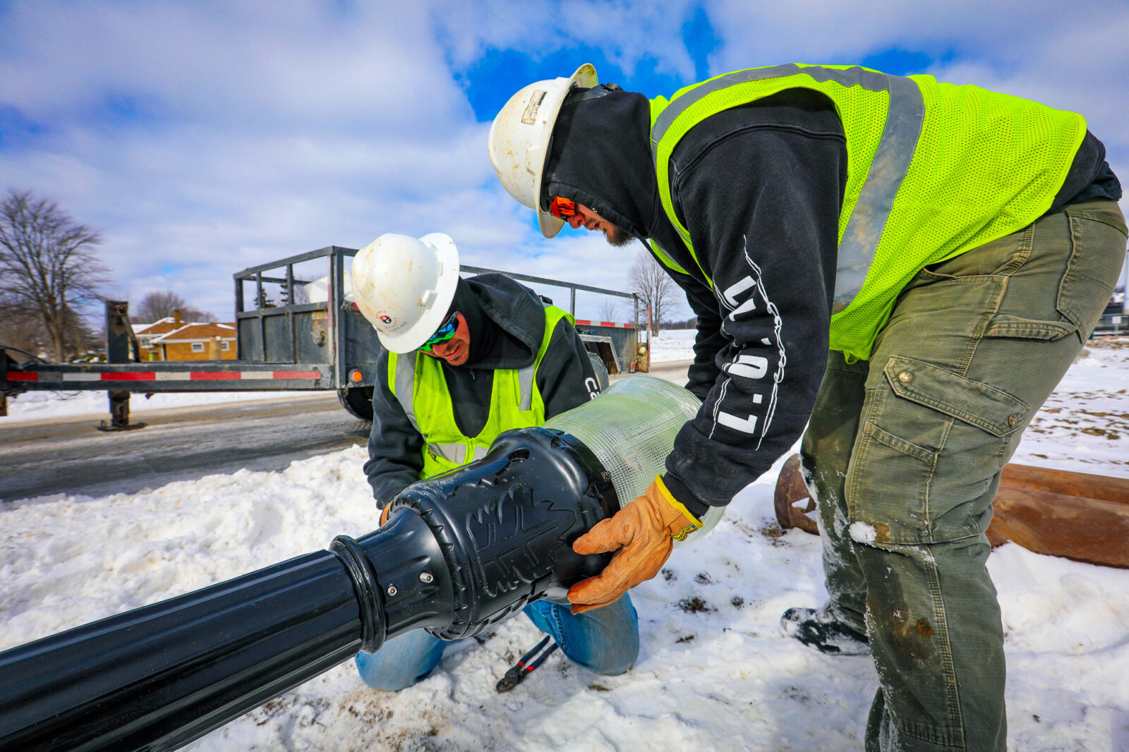 Two Harlan Electric workers installing a street light