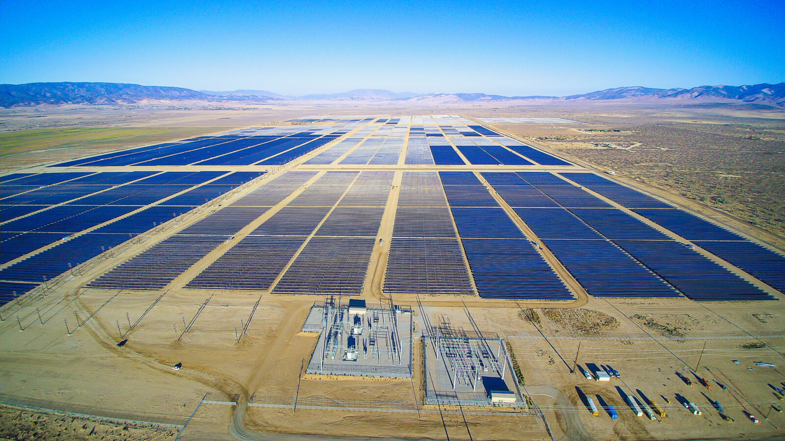 large solar farm in a valley surrounded by hills