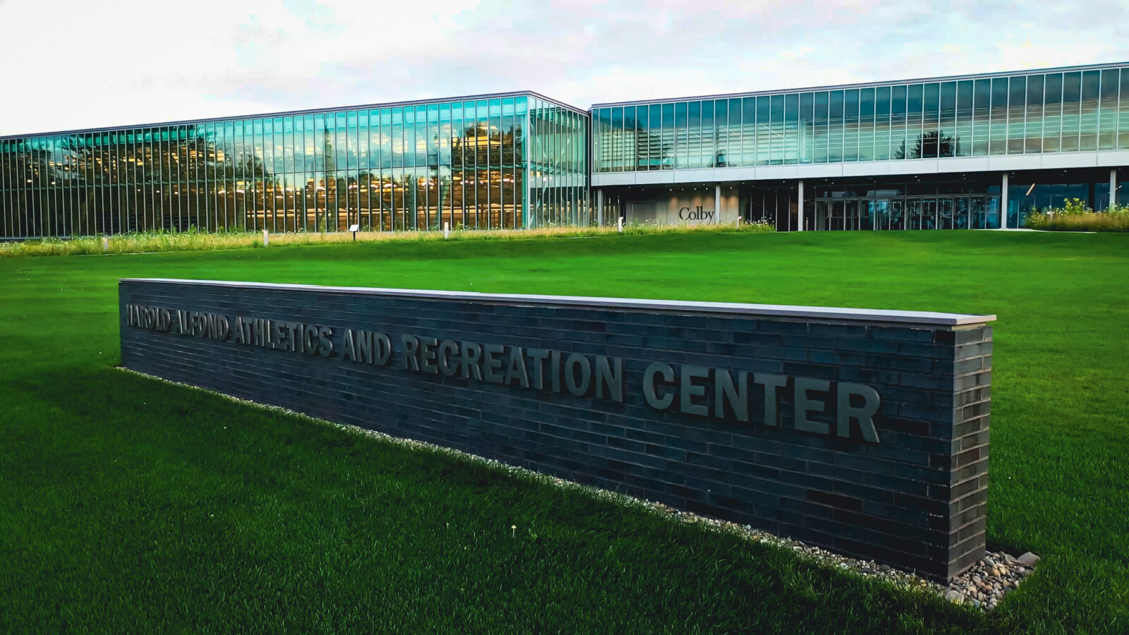 Sign outside of Colby College with buildings in the background