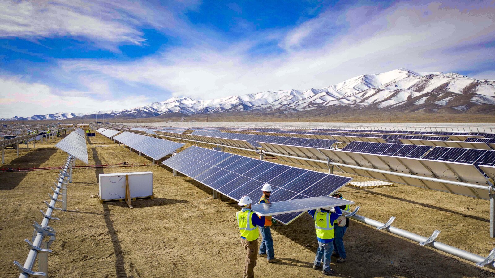 Group of workers inserting solar panels