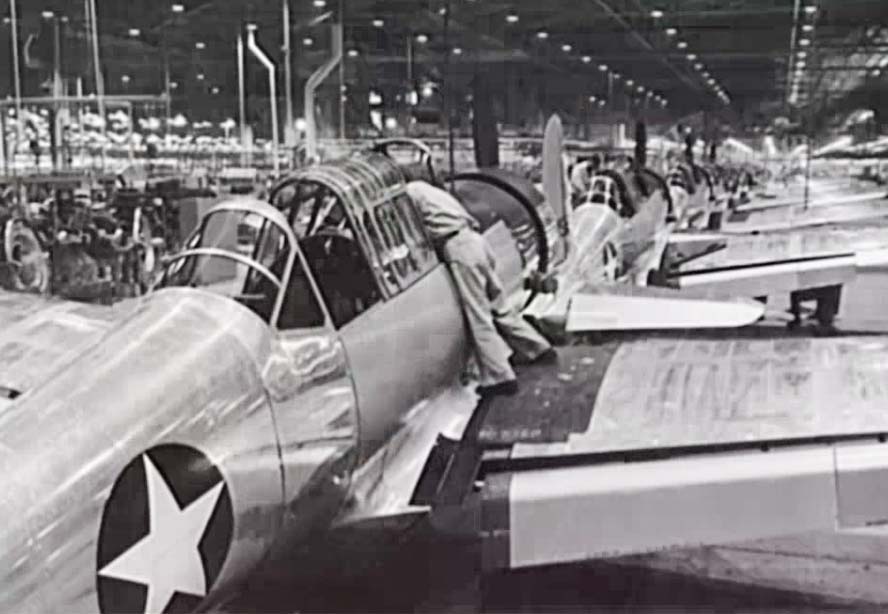 Man working on the cockpit of a military plane