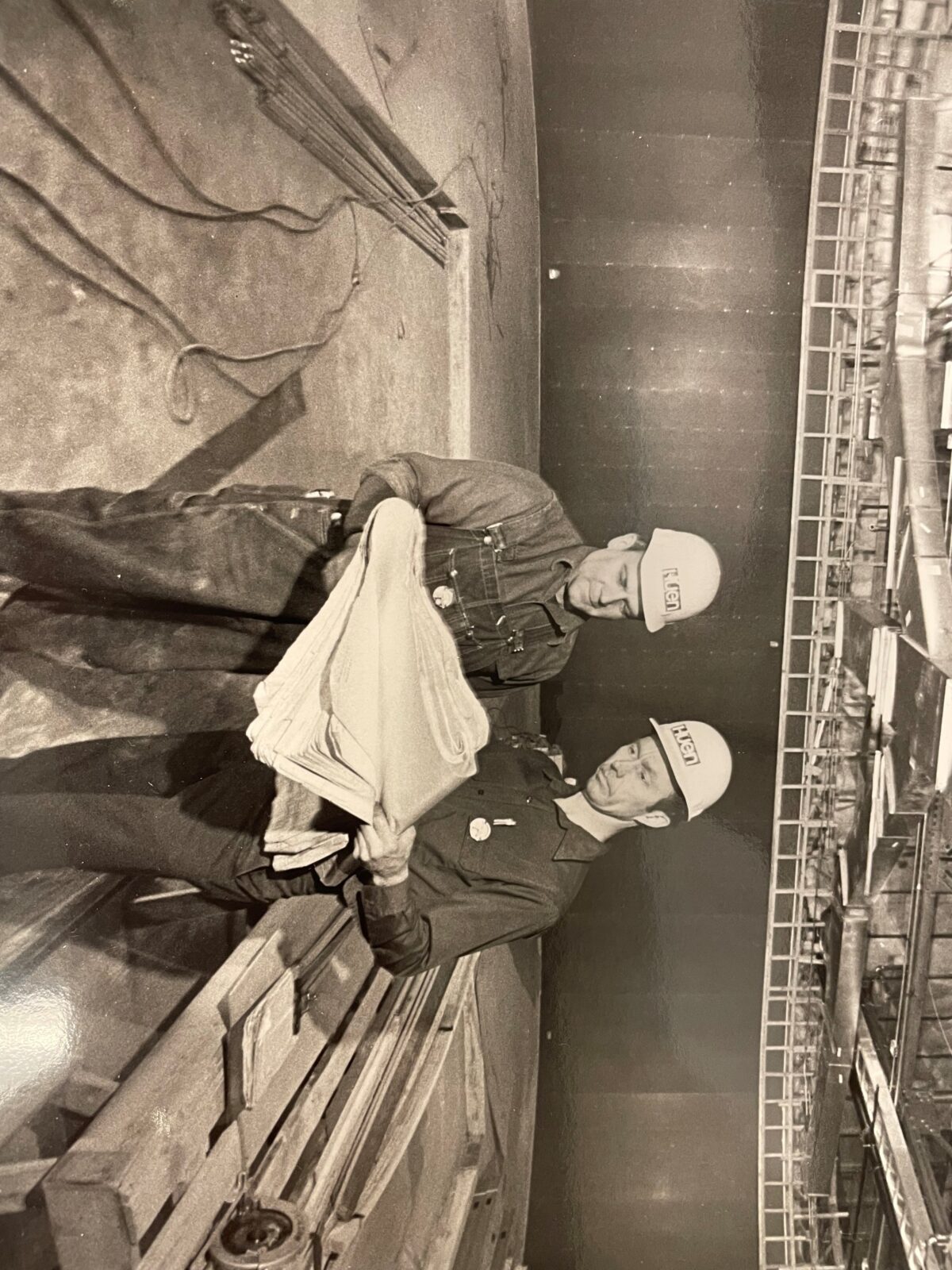 Mike hughes and jim mcgovern reviewing a blueprint