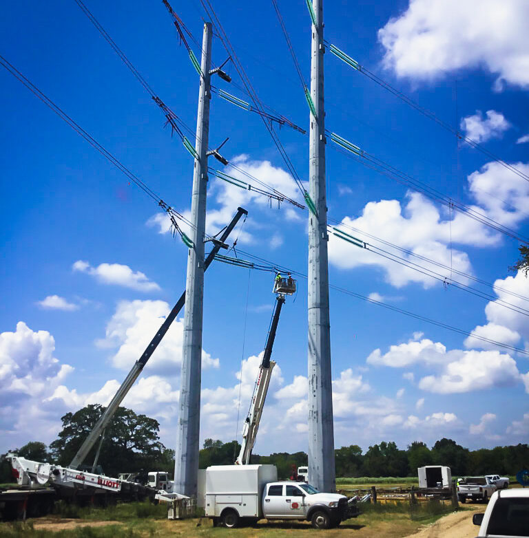 L.E. Myers employees in bucket working on transmission lines