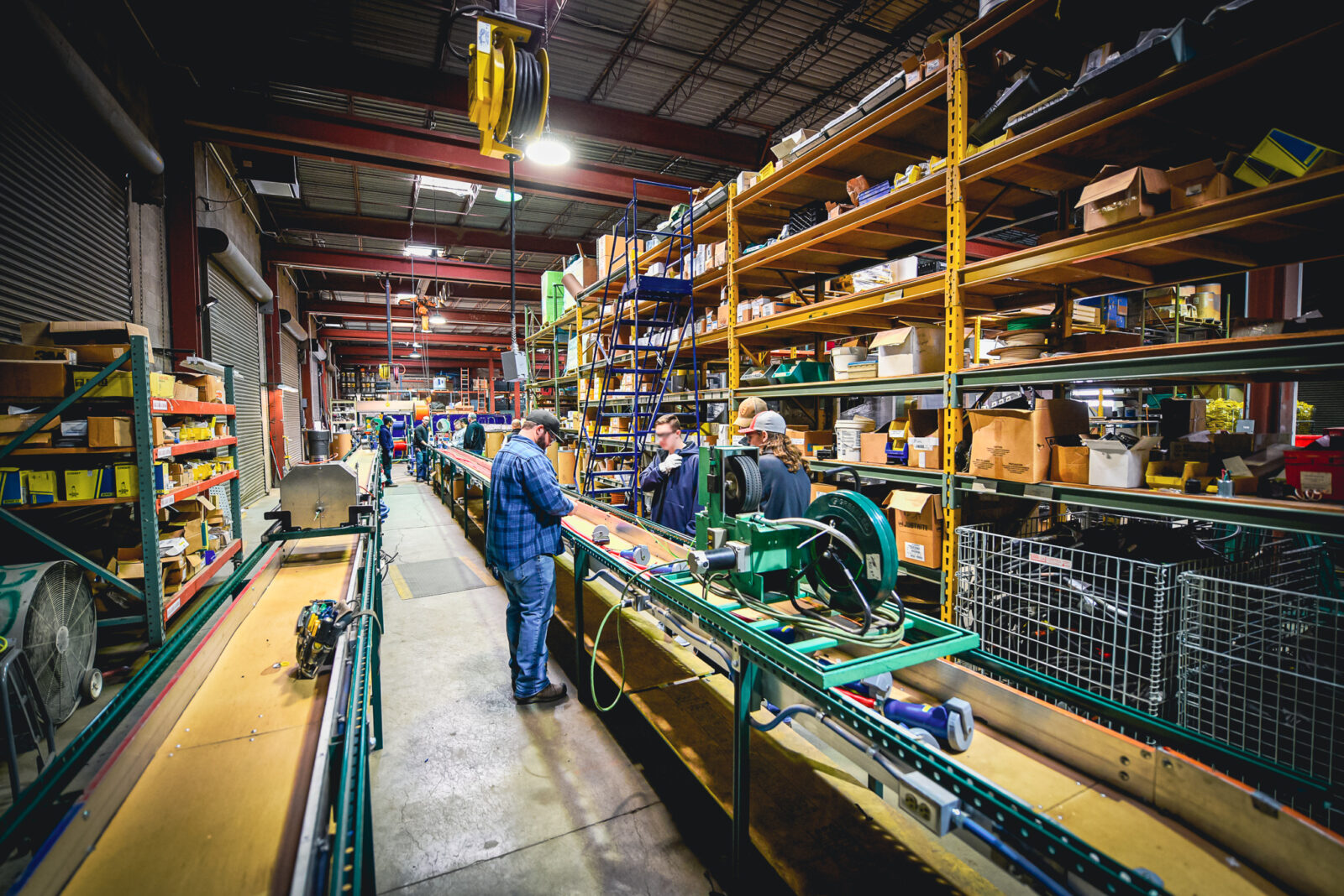 Workers on the assembly line inside a warehouse