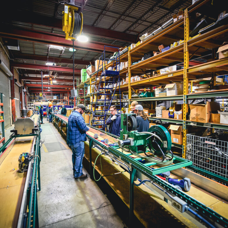 Workers on the assembly line inside a warehouse
