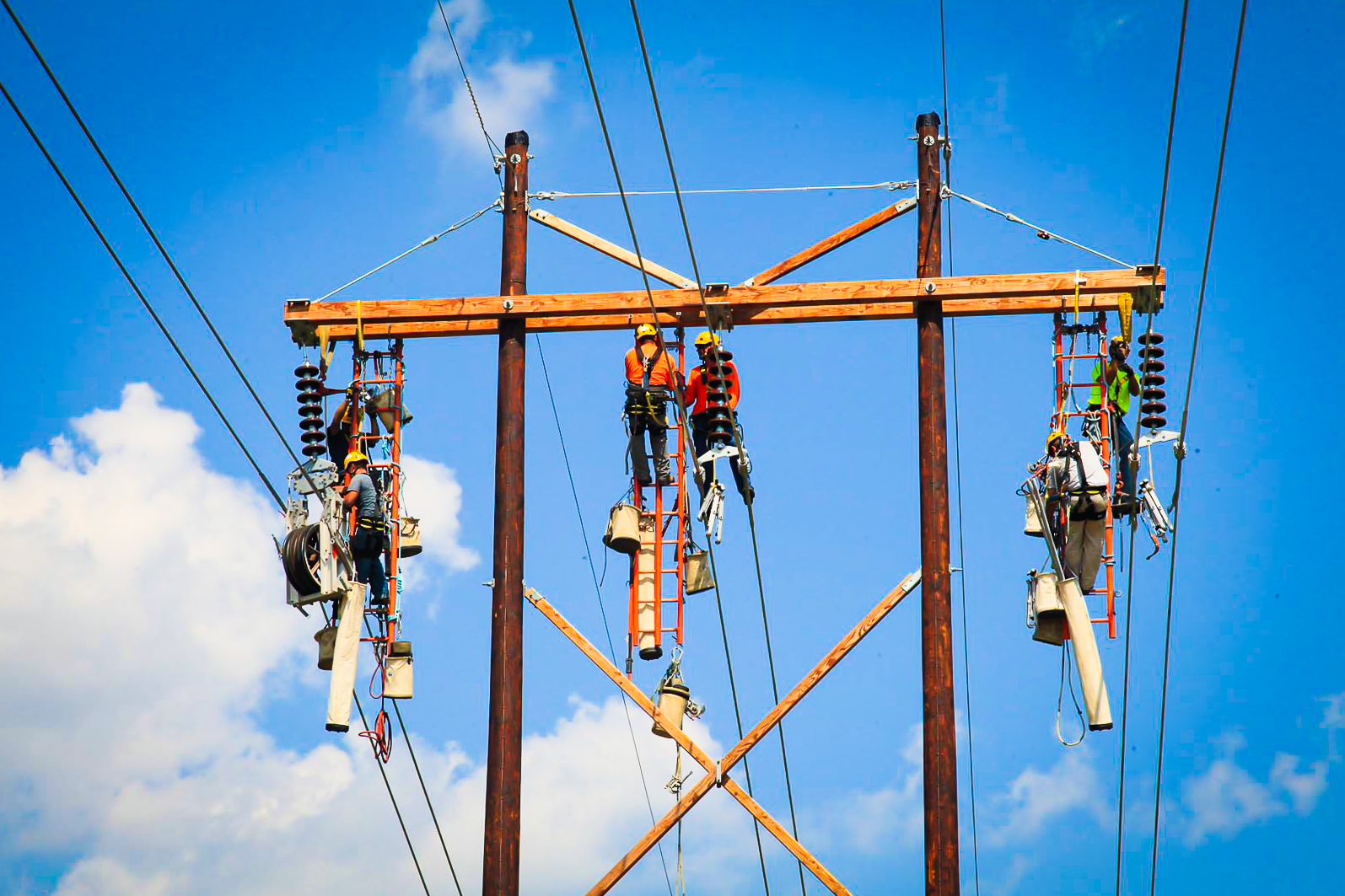 Six MYR Group employees elevated in the sky to work on transmission lines