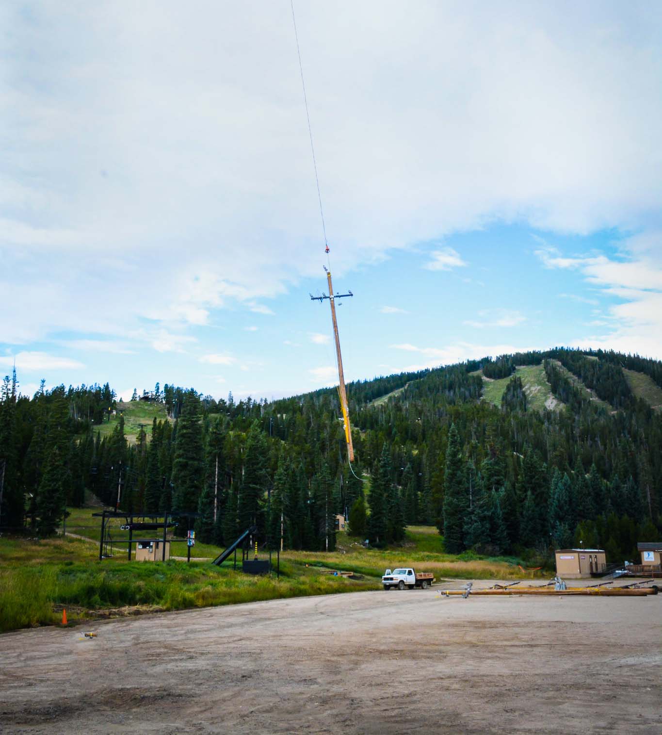 Crane lifting a power line pole