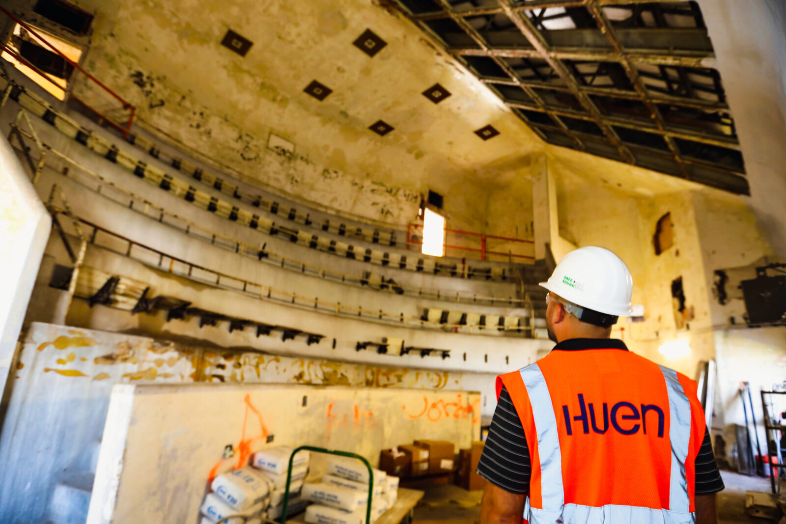 Huen worker observing a pre-constructed auditorium