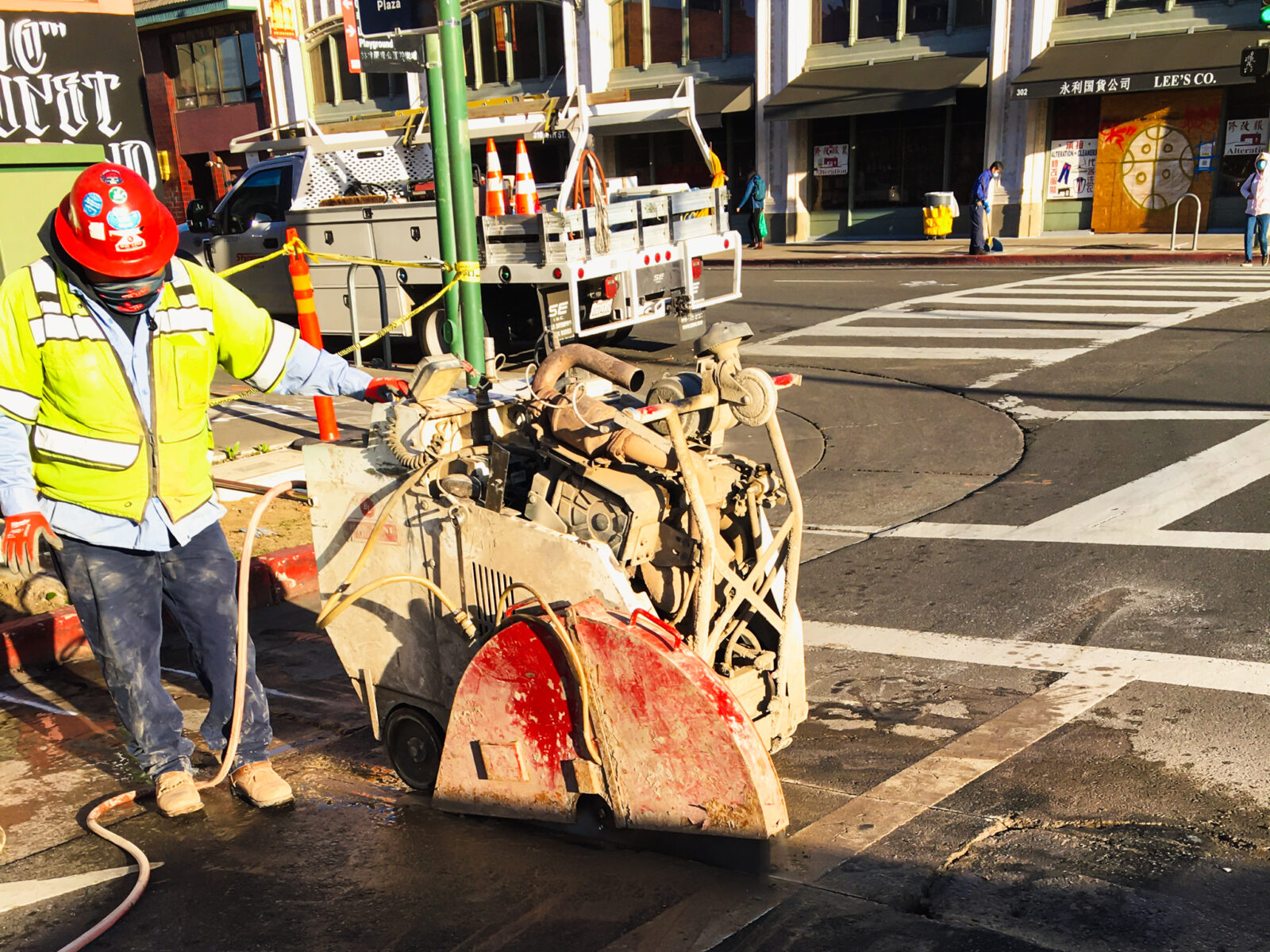 Harlan Electric worker using machinery to smooth road surface