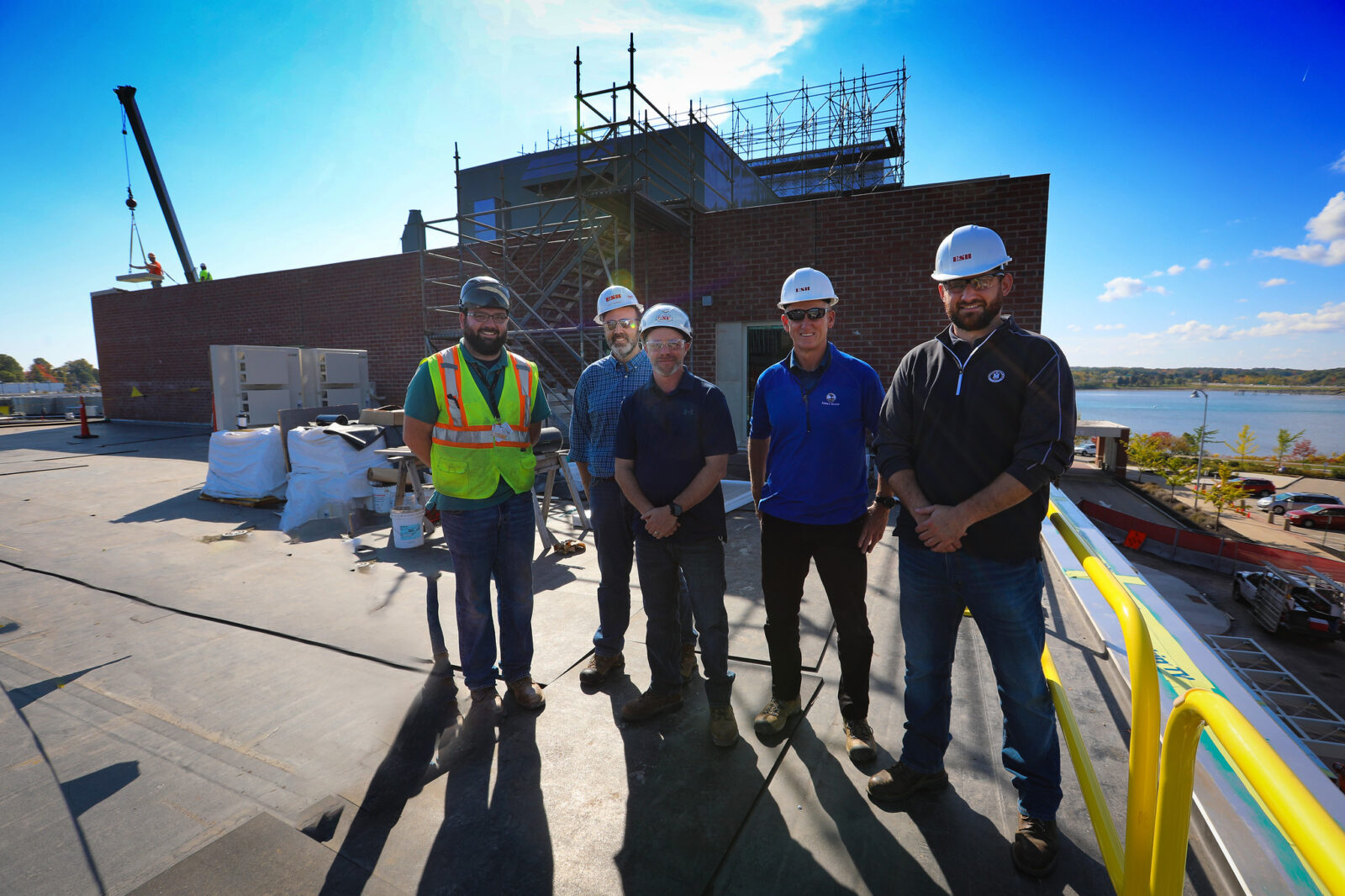five men in hard hats smiling