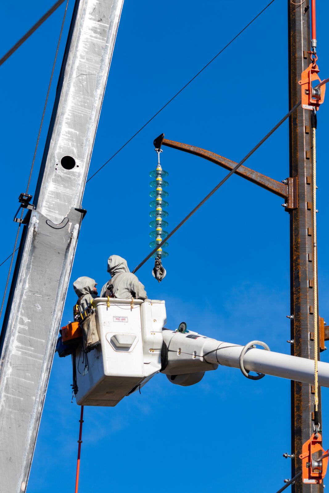 Two barehand live line construction workers