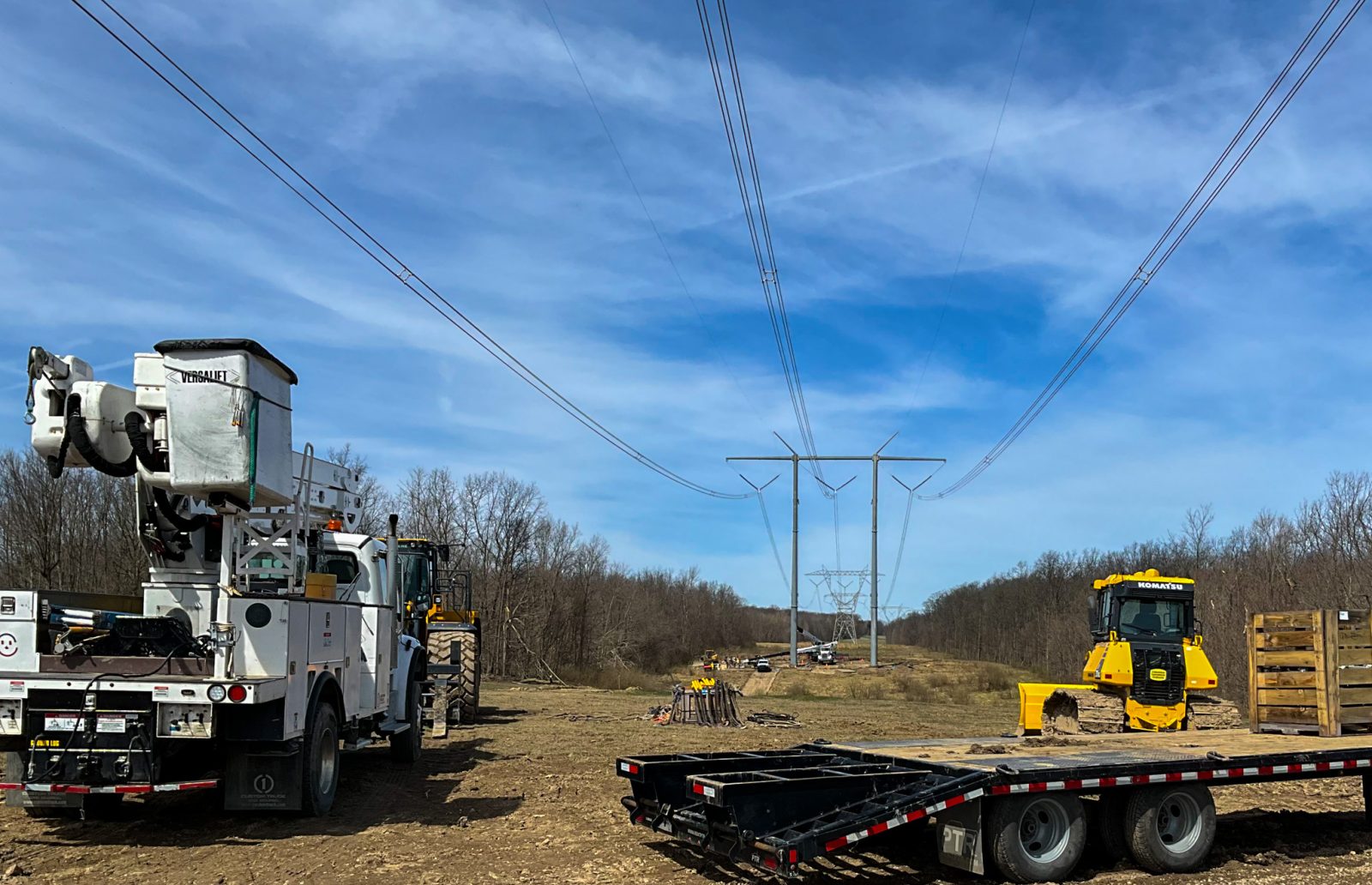 A 765kV transmission line and lattice tower restored after a storm.
