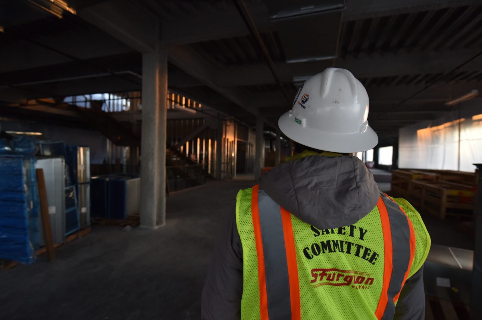 Safety construction worker in a vest and hard hat.