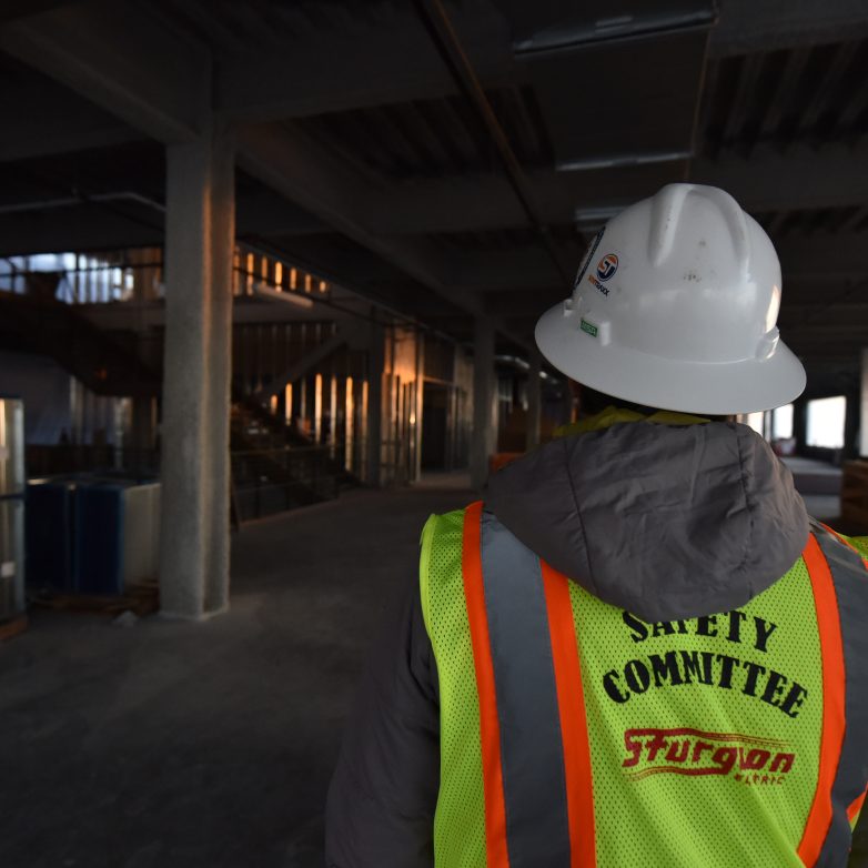 Safety construction worker in a vest and hard hat.
