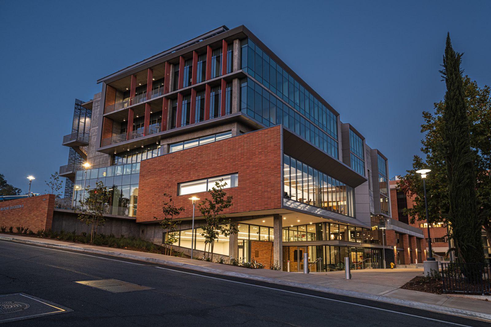 a large building with many windows lit at dusk