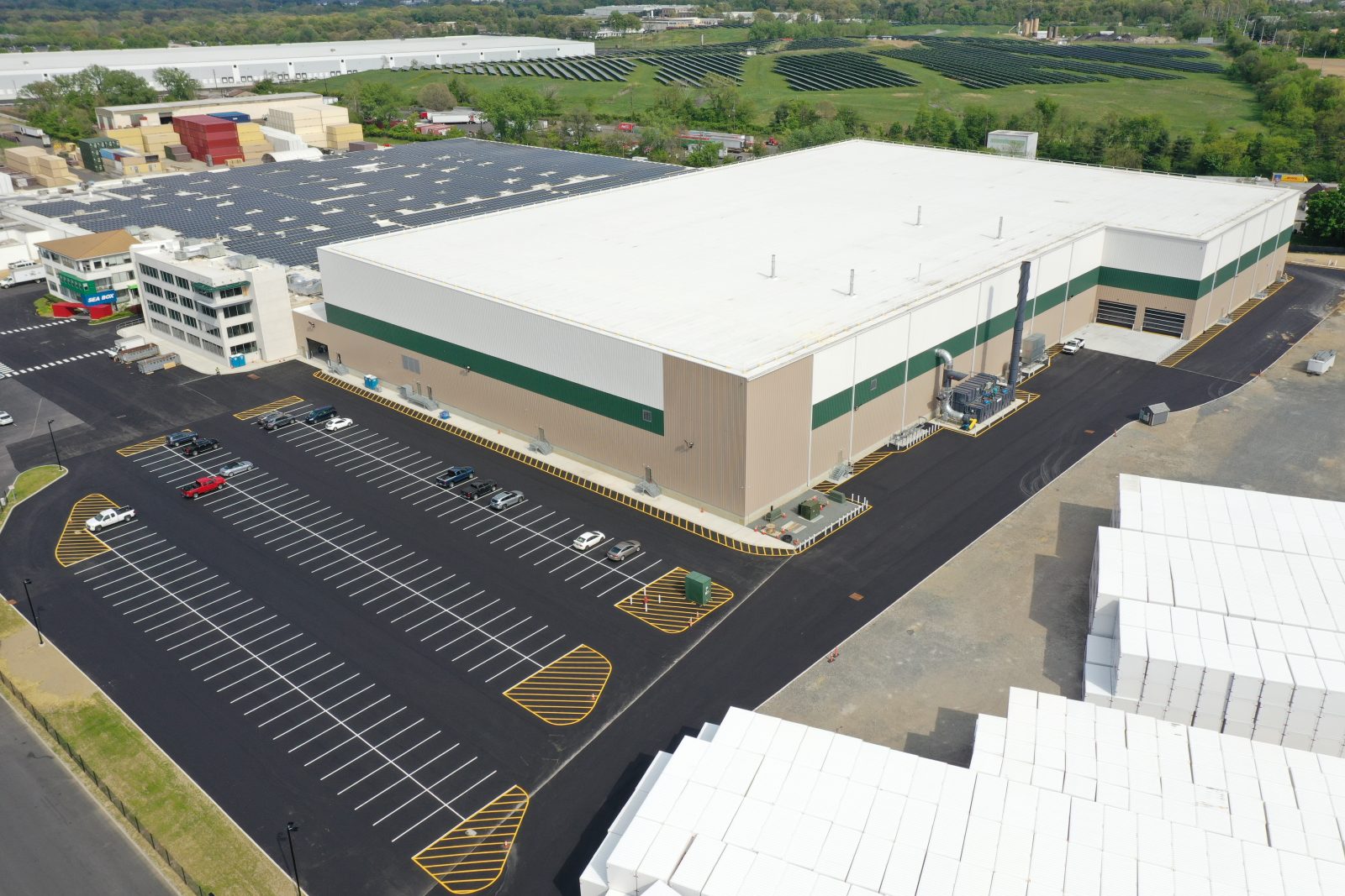 A large warehouse with a parking lot