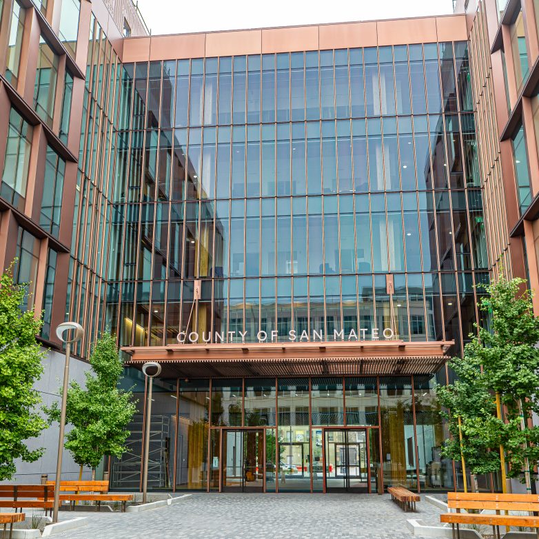 the outside of a building with lots of wood and windows